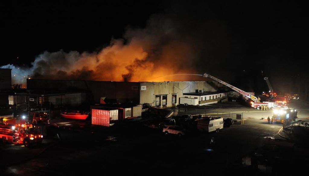 Firefighters from throughout Snohomish County battled a massive three-alarm warehouse fire along the Snohomish River in north Everett on Saturday.