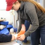 Monroe High School senior Katie Piland practices her taping technique in the sports medicine classroom in preparation for state competition. Piland plans a career in athletic training.