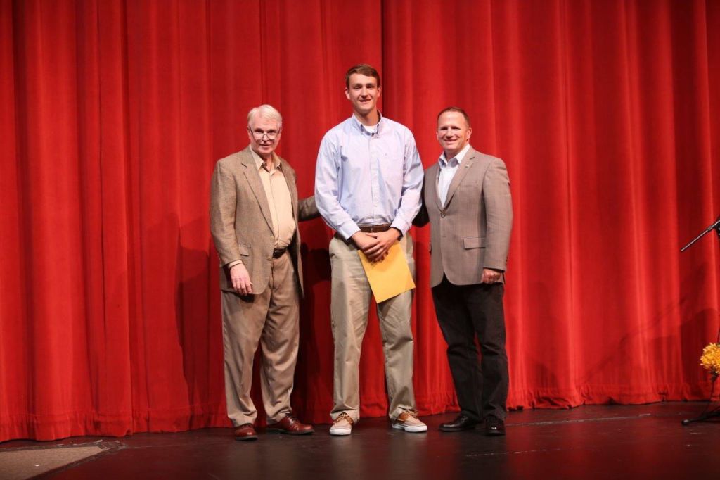 Conner Kunzman (center) won the Alan and Iza Elliott Memorial Scholarship at a May 31 awards night at Stanwood High School. The scholarship is only offered once every four years. He is congratulated by Stanwood-Camano Area Foundation board members Chuck Durland (left) and state Rep. Dave Hayes.