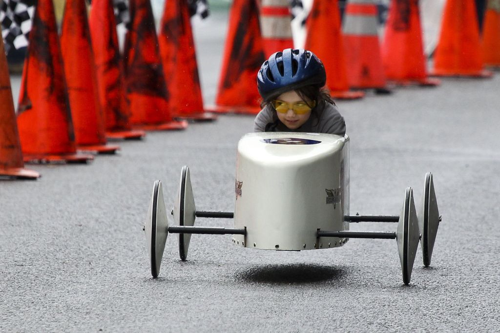 Peyton Calkins, 7, takes a peek over at her competition while racing at the Stanwood Camano Island Soap Box Derby on Saturday in Stanwood.