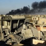 In this Dec. 25, 2015, photo, smoke rises from Islamic State positions following a U.S.-led coalition airstrike as Iraqi Security forces advance their position in downtown Ramadi, 70 miles west of Baghdad.