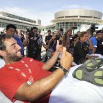 David Hernandez gives a thumbs-up as he is stretchered away upon his arrival at the Kota Kinabalu International Airport in Sabah, Malaysia, on Friday. Hernandez was among the four who were rescued after their boat capsized off the northern coast of the island of Borneo, the Malaysian coast guard said Thursday.