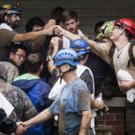 People who were rescued from Hidden River Cave celebrate on Thursday, after 18 people on a cave tour were trapped due to flash flood waters in Horse Cave, Kentucky.