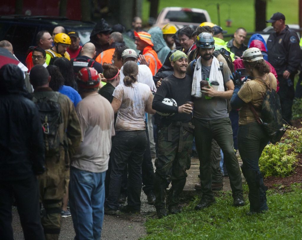 Rescued people take photos together after being rescued from Hidden River Cave on Thursday.