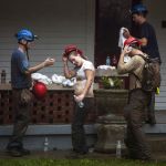 Becca Dozier middle takes off her helmet after having been rescued from Hidden River Cave on Thursday.