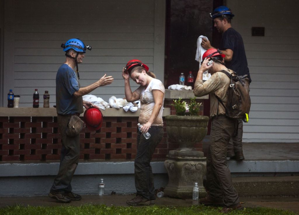 Becca Dozier middle takes off her helmet after having been rescued from Hidden River Cave on Thursday.