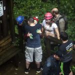 Tour guide Peggy Nims hugs a friend after she made it out of Hidden River Cave on Thursday.