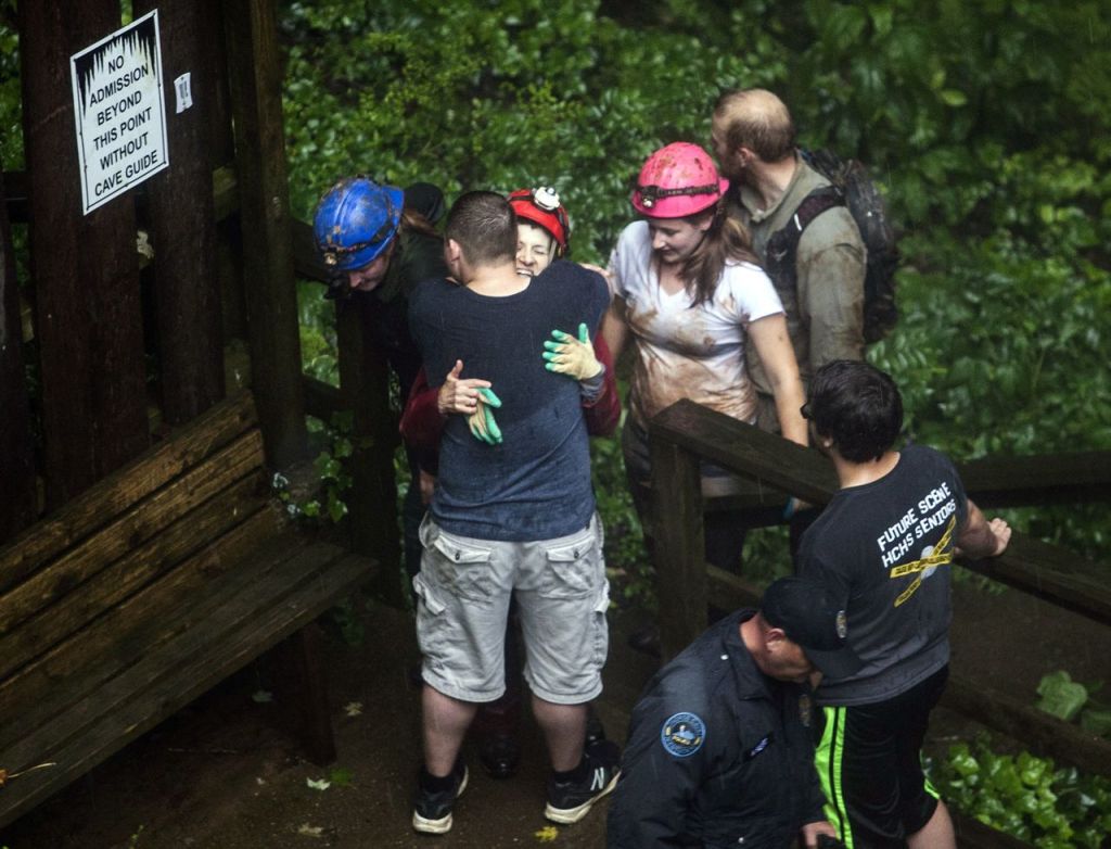 Tour guide Peggy Nims hugs a friend after she made it out of Hidden River Cave on Thursday.