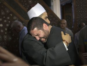 The Imam of al Thawrah Mosque, Samir Abdel Bary, gives condolences to film director Osman Abu Laban (center), who lost four relatives, all victims of Thursday&rsquo;s EgyptAir plane crash, following prayers for the dead at al Thawrah Mosque, in Cairo on Friday.