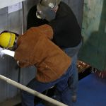 Washington Gov. Jay Inslee makes a ceremonial weld Tuesday during the keel-laying ceremony for the Suquamish.