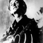 In this undated photo folk singer Woody Guthrie plays his guitar.
