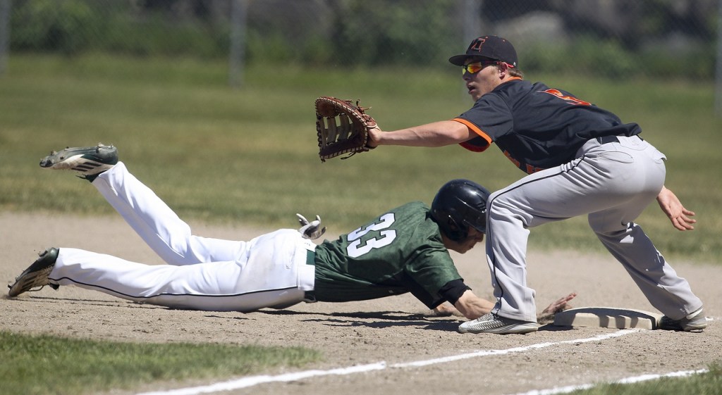 Jackson runner Justin Hampson (left) slides back into first base as Monroe first baseman Hayden Curnutt looks for the pickoff attempt during a 4A district opener game at Jackson High School on Saturday, May 7, 2016. Jackson went on to defeat Monroe 10-7.