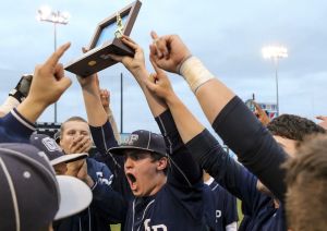 Glacier Peak&rsquo;s Cole Walchenbach raises the 3A District 1 championship trophy Monday night at Everett Memorial Stadium after the Grizzlies defeated Lynnwood 5-4 in eight innings.