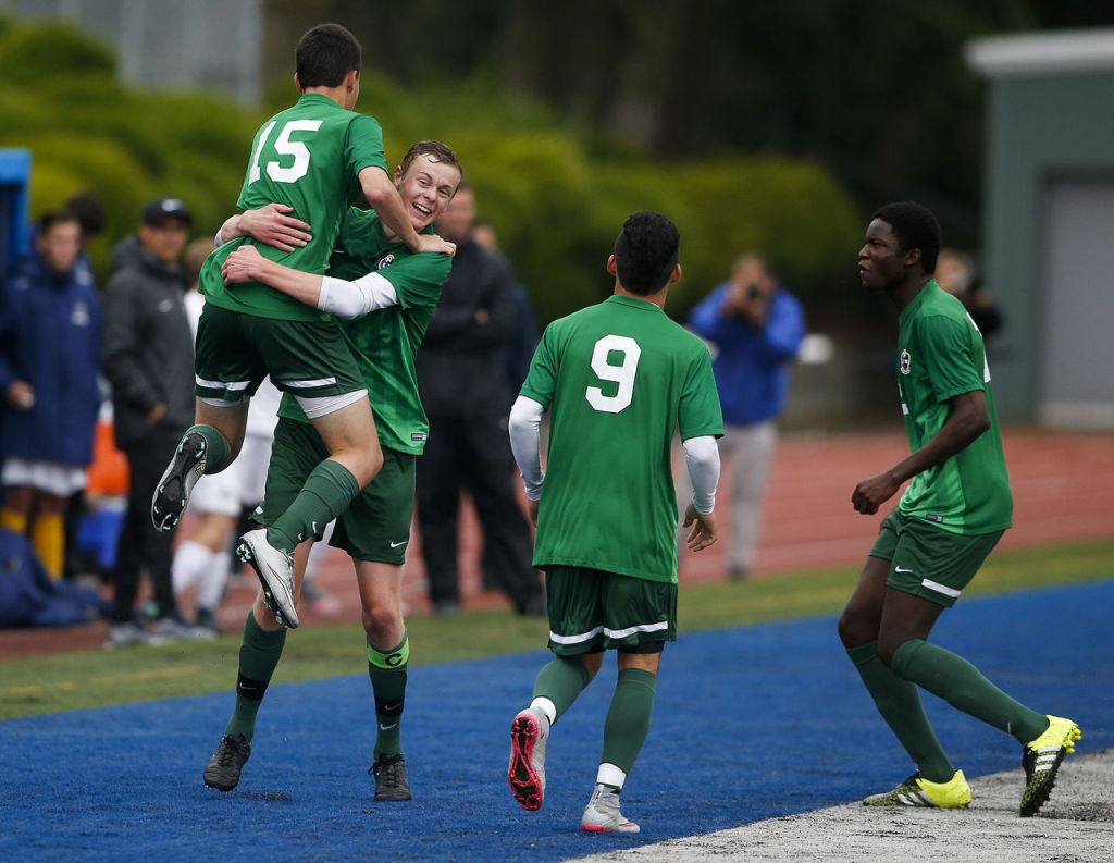 After scoring in the second half, Edmonds-Woodway&rsquo;s Kyle Aure (15) is lifted up by teammate Jake Stevenson after scoring a goal in the second half as Jose Aleman-Cruz (9) and Njaka Jammeh run to join the celebration during the 3A District 1 championship game on Saturday at Shoreline Stadium.