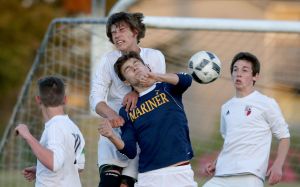 Snohomish&rsquo;s Brennan Judy and Mariner&rsquo;s Edward Katynskiy leap for a header during the 4A District 1 championship match on Thursday at Goddard Stadium in Everett.