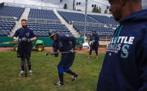 The AquaSox&rsquo;s Jose Leal (center) shows off his bunting form to former Mariner and current Everett hitting coach Brian Hunter (right) before taking batting practice Tuesday at Everett Memorial Stadium.