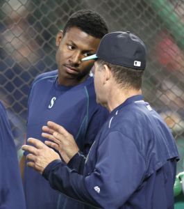 Mariners first-round draft pick Kyle Lewis talks with Seattle batting coach Edgar Martinez during batting practice before the team&rsquo;s baseball game against the Texas Rangers on Saturday.