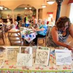 Kevin Clark / The Daily Herald                                Dora Rice gathers another drawing for residents and guests of Everett Garden Court Retirement Community to paint pictures of the elderly dogs and cats available for adoption Friday afternoon in Everett on June 10, 2016.