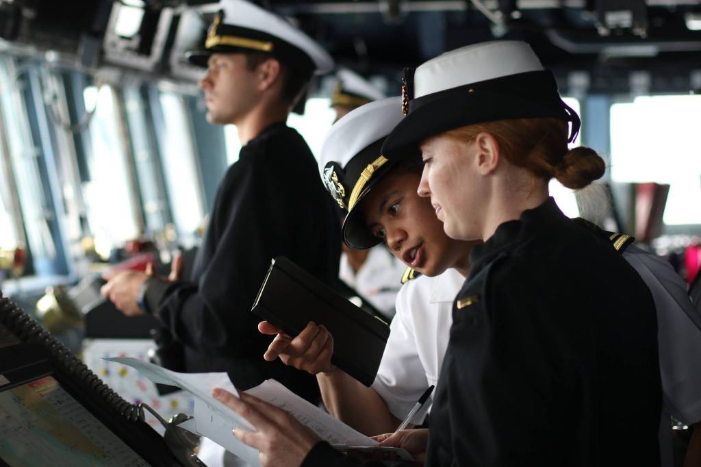 Lt. j.g. Antonio Roa (center) talks with Ensign Kaitlyn South on the bridge of the USS Gridley during a trip to Seattle for Seafair on Tuesday. (Andy Bronson / The Herald)