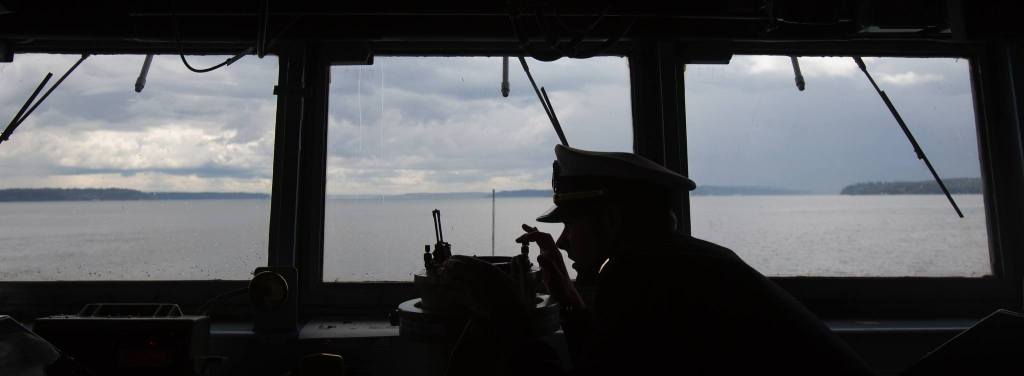 Ensign Tanner Roach takes a bearing from the bridge of the USS Gridley. (Andy Bronson / The Herald)