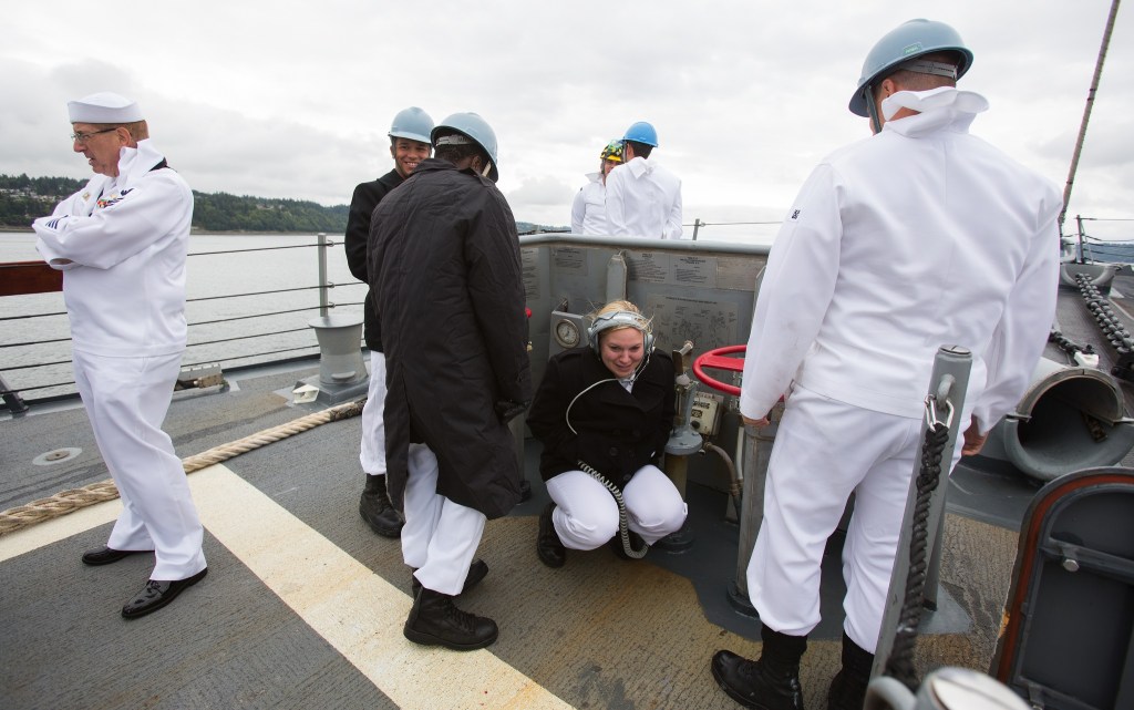 Seaman Autumn Franks ducks from the wind as the USS Gridley, the newest guided missile destroyer to be based at Naval Station Everett, leaves port for Seattle on Tuesday. (Andy Bronson / The Herald)