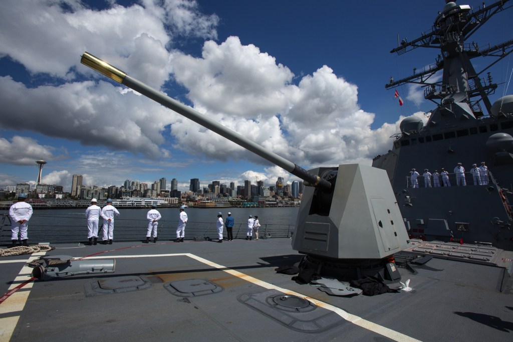 Sailors line the railings aboard the USS Gridley as it cruises the waterfront in Seattle on Tuesday. (Andy Bronson / The Herald)