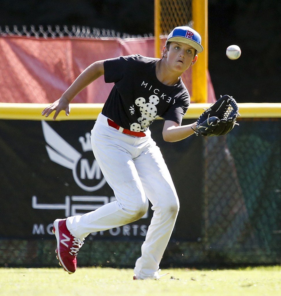Pacific Little League All-Star team member Kam Jordan chases down a fly ball during a practice at Lynndale Park in Lynnwood on Tuesday. (Ian Terry / The Herald)