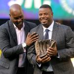 Former Seattle SuperSonic Gary &lsquo;The Glove&rsquo; Payton (left) presents Ken Griffey Jr. with a bronze glove during Griffey&rsquo;s number retirement ceremony Saturday at Safeco Field. (Kevin Clark / The Herald)