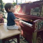 Rigsby, 4, and Kesler, 3, Douey of Canada test out one of the Street Tunes pianos while visiting Everett with their parents earlier this week. This piano, decorated by Alexander Vincini, is located in front of the Vintage Cafe on Hewitt Avenue. (Gale Fiege / The Herald)