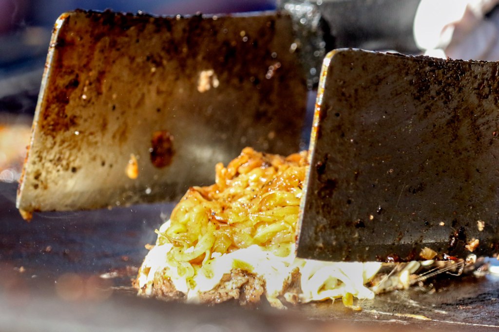 A Philly cheesesteak is being prepared Friday during the annual of Taste of Edmonds Friday afternoon in downtown Edmonds. (Kevin Clark / The Herald)