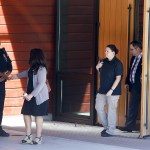 Mukilteo police officer Myron Travis greets attendants as they leave a memorial service for July 30 Mukilteo shooting victim Jordan Ebner at Rosehill Community Center in Mukilteo on Monday. (Ian Terry / The Herald)