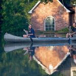 Danny and Alys Messenger canoe away from their flooded home after reviewing the damage in Prairieville, Louisiana, on Tuesday. As waters begin to recede in parts of Louisiana, some residents struggled to return to flood-damaged homes on foot, in cars and by boat. (AP Photo/Max Becherer)