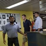 Accompanied by Brazilian lawyer Sergio Riera, second from right, American Olympic swimmers Gunnar Bentz, center, and Jack Conger, right, leave the police station at Rio International airport early Thursday. The two were taken off their flight from Brazil to the U.S. on Wednesday by local authorities amid an investigation into a reported robbery targeting Ryan Lochte and his teammates. The man at left is unidentified. (AP Photo/Mauro Pimentel)