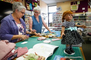 Volunteers are dressing up dolls for Christmas House gifts