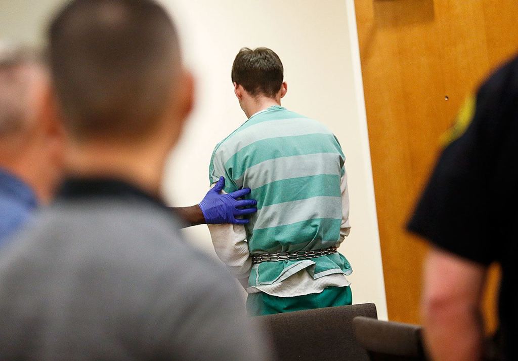 Allen Ivanov is taken from the Snohomish County Superior Courtroom in Everett following his arraignment, Monday, on three counts of murder. The 19-year-old could face the death penalty. (Dan Bates/The Herald)