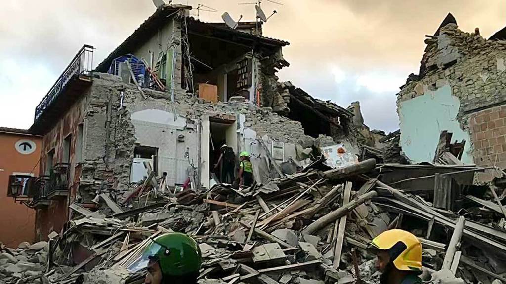This still image taken from video shows rescuers searching a collapsed building in Amatrice, central Italy, where a 6.1 earthquake struck just after 3:30 a.m. on Wednesday. (AP Photo)