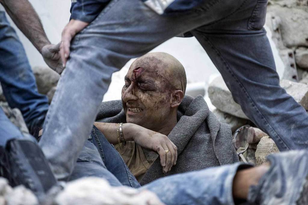 A man is pulled out of the rubble following an earthquake in Amatrice Italy, on Wednesday, Aug. 24, 2016. (Massimo Percossi/ANSA via AP)