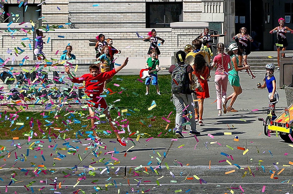 As two confetti cannons are fired off near the end of the commercial, young actors playing students outside Everett High School appear in a celebratory mood. (Dan Bates/The Herald)