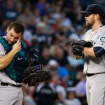Mariners catcher Mike Zunino (left) wipes his face as he listens to starter James Paxton during the first inning of a game Thursday against the White Sox in Chicago. (AP Photo/Nam Y. Huh)