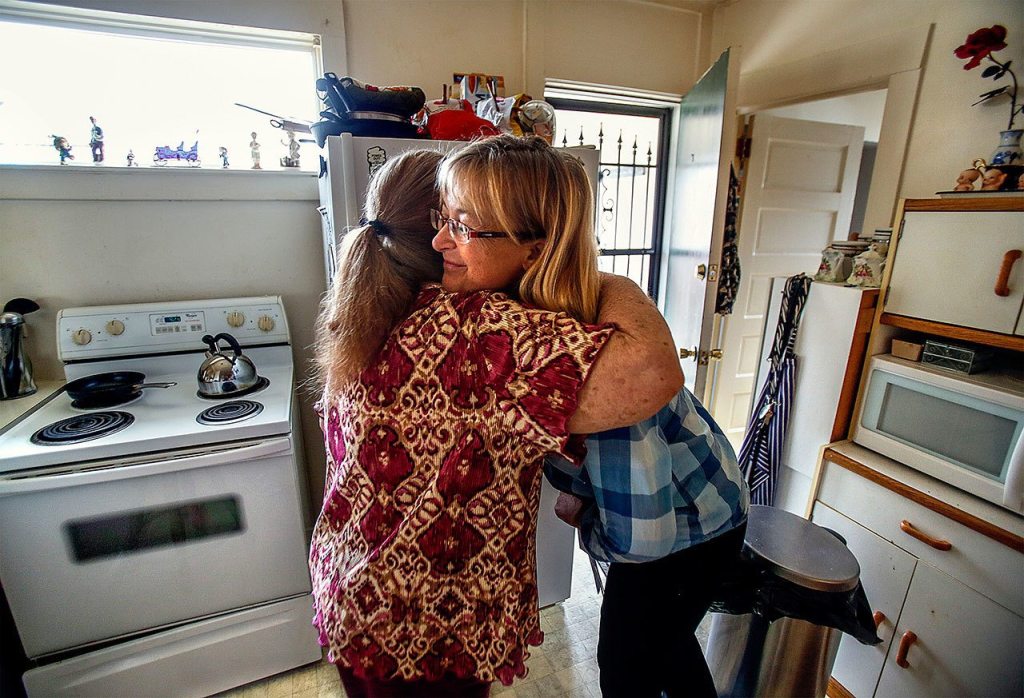 Mildred Hawkins, 85 (left) gives Meals on Wheels driver Jane Slager a big hug before she goes on to her next delivery. (Dan Bates/The Herald)