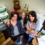 Volunteer coordinator Kim David (center), curator Amalia Kozloff (left) and registrar Heather Schaub (right) pause in one of the Everett Museum of History&rsquo;s storage rooms with items they have carefully catalogued, wrapped and boxed in the Culmback Building basement. (Dan Bates / The Herald)