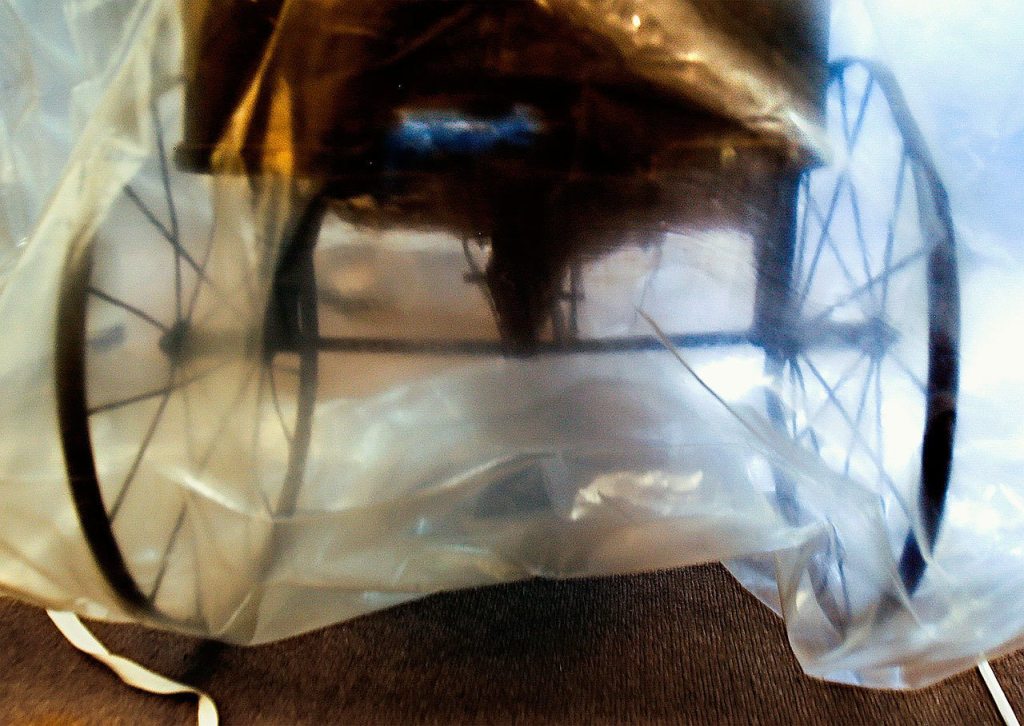 A late 19th or early 20th-century child&rsquo;s cart is shrouded to protect it while stored in the basement of the Culmback Building for the Everett Museum of History. (Dan Bates / The Herald)