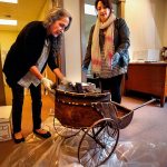 Kim David (left) and Amalia Kozloff put some large sections together on a turn-of-the-century kids cart. (Dan Bates / The Herald)