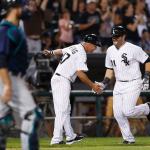 The White Sox&rsquo; Alex Avila (right) celebrates with third base coach Joe McEwing after hitting a home run off the Mariners&rsquo; Vidal Nuno during the fifth inning of a game Saturday in Chicago. (AP Photo/Kamil Krzaczynski)