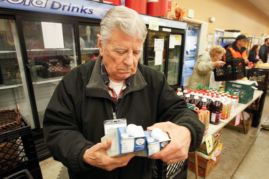 Volunteer Don Asmus sorts milk containers at the Marysville Community Food Bank on Nov. 13, 2015. &ldquo;We&rsquo;re usually busiest around Thanksgiving and Christmas,&rdquo; Asmus said. (Ian Terry / The Herald, file)