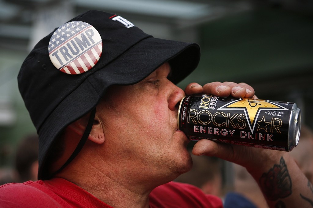 Craig Rhodes, of Black Diamond, finishes an energy drink before entering Xfinity Arena for a rally for Republican presidential nominee Donald Trump on Tuesday. (Ian Terry / The Herald)