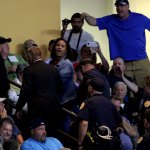 A protester yells as she is escorted out while Donald Trump speaks to supporters at Xfinity Arena on Tuesday in Everett. (Andy Bronson / The Herald)