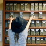 An employee arranges containers of marijuana on shelves at a retail and medical cannabis dispensary in Boulder, Colorado, on Aug. 11. (AP Photo/Brennan Linsley)