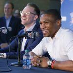 Oklahoma City Thunder guard Russell Westbrook (right) and Sam Presti (left) general manager, laugh during a news conference to announce that Westbrook has signed a three-year contract extension. (AP Photo/Sue Ogrocki)