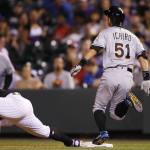 Miami Marlins pinch-hitter Ichiro Suzuki, right, beats the throw to Colorado Rockies first baseman Mark Reynolds for an infield single in the eighth inning Saturday in Denver. The hit was the 2,999th in Suzuki&rsquo;s career. (AP Photo/David Zalubowski)
